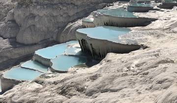 Natural thermal pools at Pamukkale with vibrant blue water.