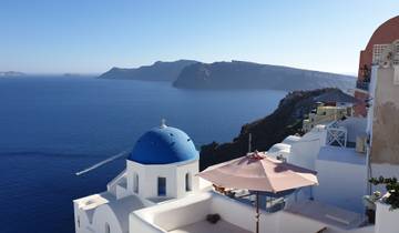 Stunning view of Santorini with blue-domed churches and sea.