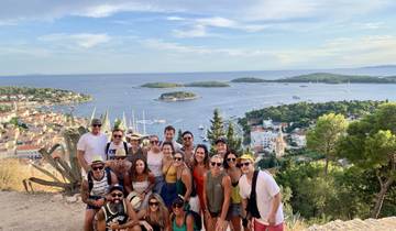 Large group of people with a scenic coastal view in the background.