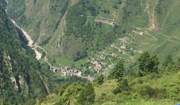 A small village nestled in a green mountainous valley.