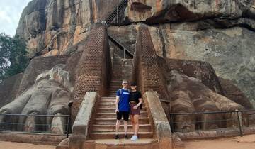 Couple standing at the base of the Lion Rock Fortress.
