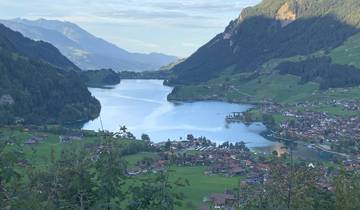 Scenic view of a lake with small towns and mountains.