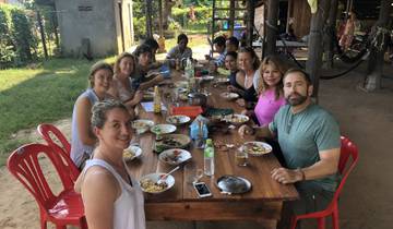 Group enjoying a meal around a table.