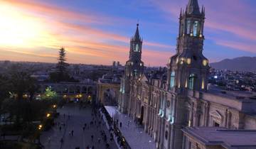 A beautiful cathedral with a vibrant sunset sky in the background.