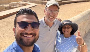 Three people smiling with the Sphinx in the background.