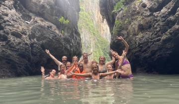 Group of people posing in a water-filled canyon.