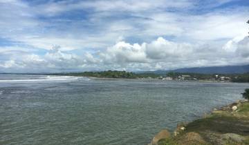 Panoramic view of a coastline with distant mountains.