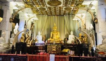 Golden Buddha statues adorned with decorations inside a temple.
