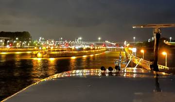 Night view of a river with lights reflecting on the water.