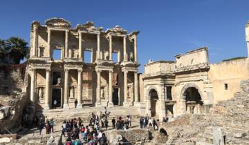 Ruins of the Library of Celsus with tourists walking around.