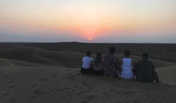 People watching a sunset in the desert.