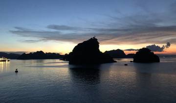 Scenic view of ocean and islands at sunset.