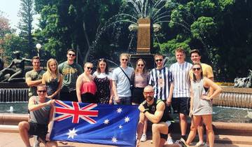 A group photo in front of a fountain holding an Australian flag.