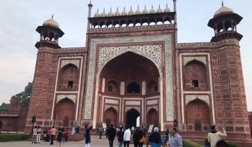 Large crowd near a historical gate at sunset.