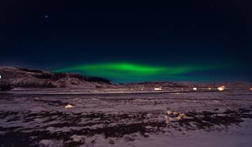 Northern lights over a snowy landscape.