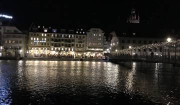 Night view of a city with reflections on water.
