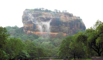 Sigiriya rock fortress rising above the trees.