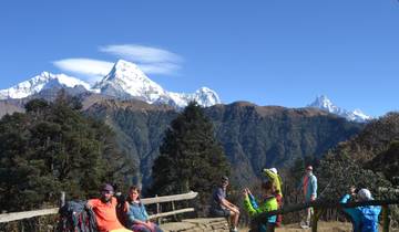 Group of hikers with snowy mountains in the background.