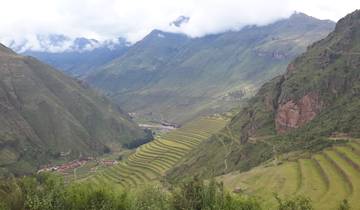 Terraced landscape with mountains under a cloudy sky.