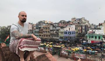 Person sitting with a cityscape view from above.