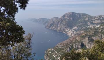 Panoramic view of a coastline with cliffs and sea.