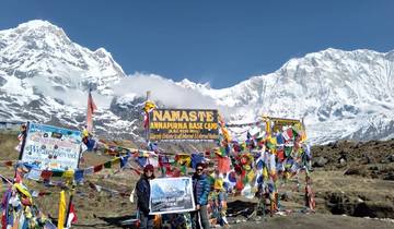 People standing with flags at Annapurna Base Camp