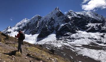 Mountain climber near snow-capped peaks.