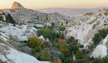 Scenic view of a valley with rock formations and a town.
