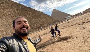 Selfie in front of the pyramids with two people posing.
