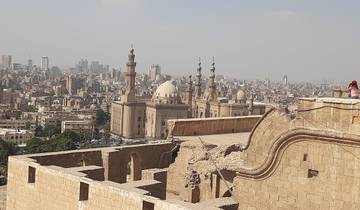 Aerial view of a city with mosques in the foreground.