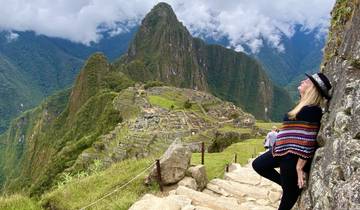 Person posing with Machu Picchu in the background.