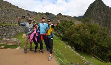 Group of people posing with Machu Picchu in the background.
