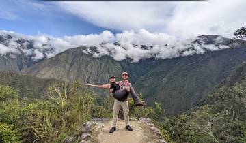 Man carrying a woman in a mountain landscape.