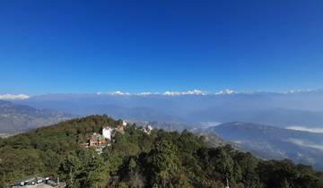 Scenic view of hills and mountains under a clear sky.