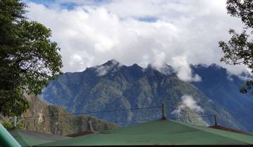 Mountains visible through a break in the clouds, viewed from a terrace.