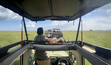 Safari view from a vehicle with vast plains.