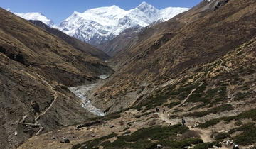 Expansive mountain landscape with a winding trail.