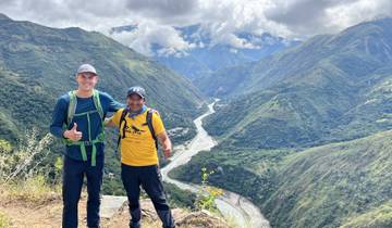 Two people overlooking a river valley in Peru.