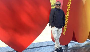 A man standing in front of a colorful hashtag sign.