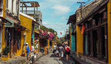 A busy street with shops and people in a colorful town.
