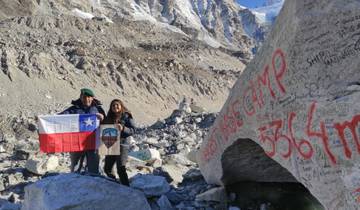 Two people with flags at base camp.