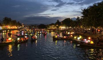 River illuminated with colorful lanterns at night.