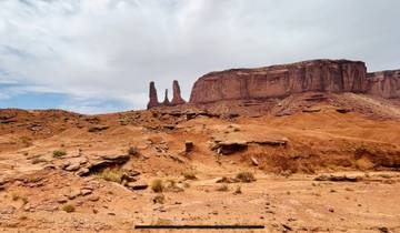 Arid landscape with notable rock formations in Monument Valley.