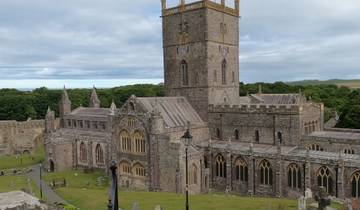 Stone cathedral with clock tower and arched windows