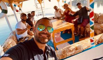 Group of people enjoying a river cruise on a boat.
