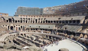 Interior view of the Colosseum with tourists exploring.
