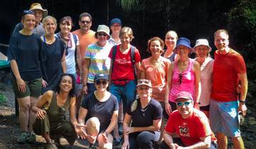 Outdoor group photo of people standing on a trail.