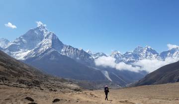 Hiker in a vast mountain landscape.