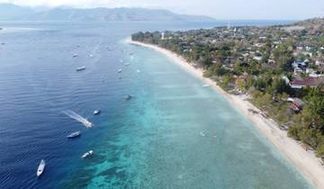 Aerial view of a coastal area with boats and houses.