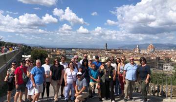 Large group with a cityscape, featuring a famous dome and river.